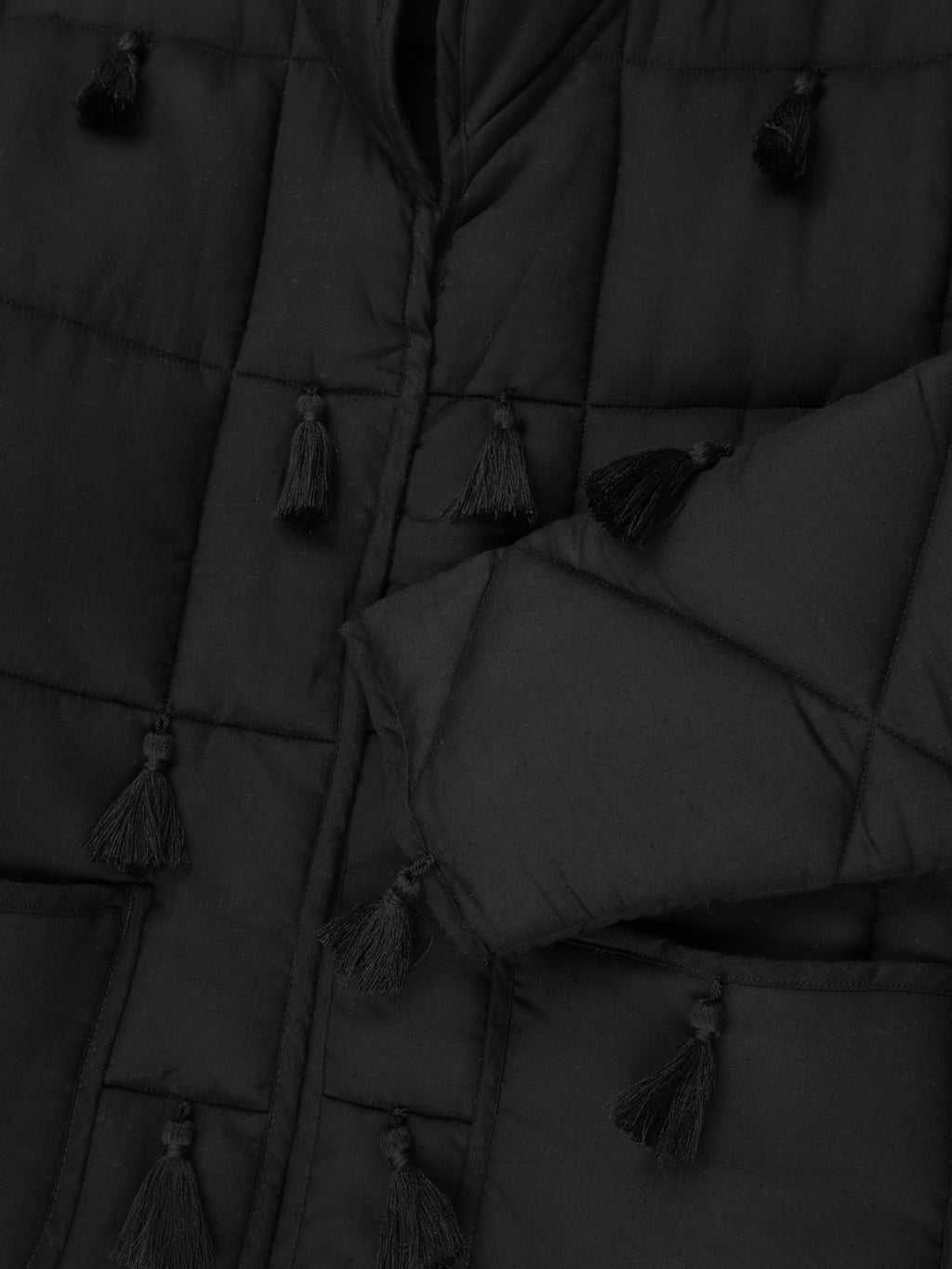 Black Dromen Tassel Jacket fabric detail back with tassel details on a light gray background