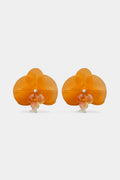 A pair of orange orchid-shaped earrings with small white pearl-like centers and delicate pink and yellow accents, displayed on a clean light gray background.