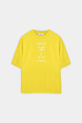 A bright yellow short-sleeve t-shirt with a white graphic print on the front featuring the word 'LOVER' and a stylized palm tree, displayed flat against a light gray background.