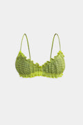 A citrus green and khaki patterned bralette top with thin shoulder straps and ruffled trim, displayed against a solid light gray background.